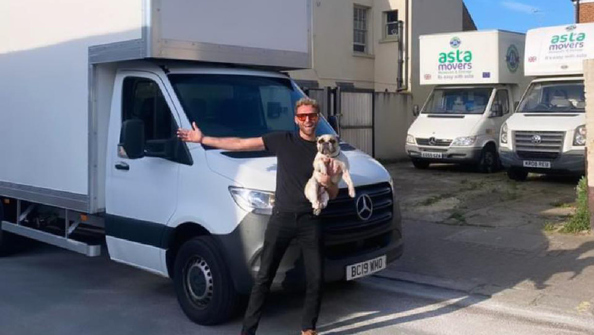 asta movers employee with a dog and vans